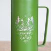 Close-up of laser engraved camping design with two bears on a green metal thermos.