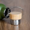 Close-up of a bamboo and stainless steel thermos lid with metal carrying handle.
