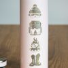 Close-up of laser-engraved winter sports icons on a pink thermos.
