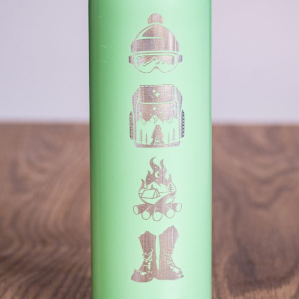 Close-up of laser-engraved winter sports icons on a mint green 750ml thermos.