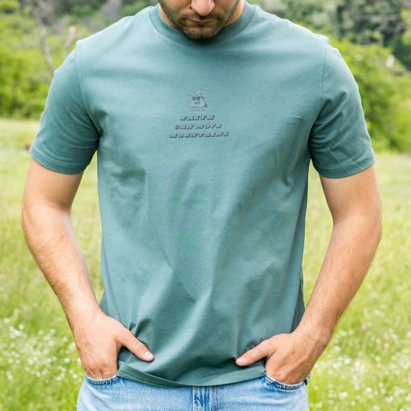 Front view of green organic cotton t-shirt with Faith Can Move Mountains chest print