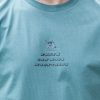 Close-up front chest print on green organic cotton Faith Can Move Mountains t-shirt
