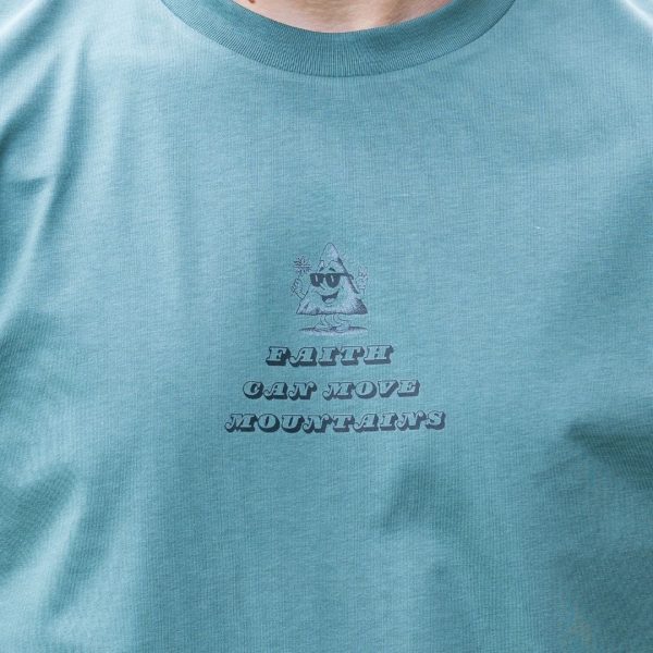 Close-up front chest print on green organic cotton Faith Can Move Mountains t-shirt