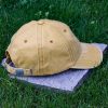 Back view of yellow vintage organic cotton baseball cap with adjustable metal buckle strap and washed finish