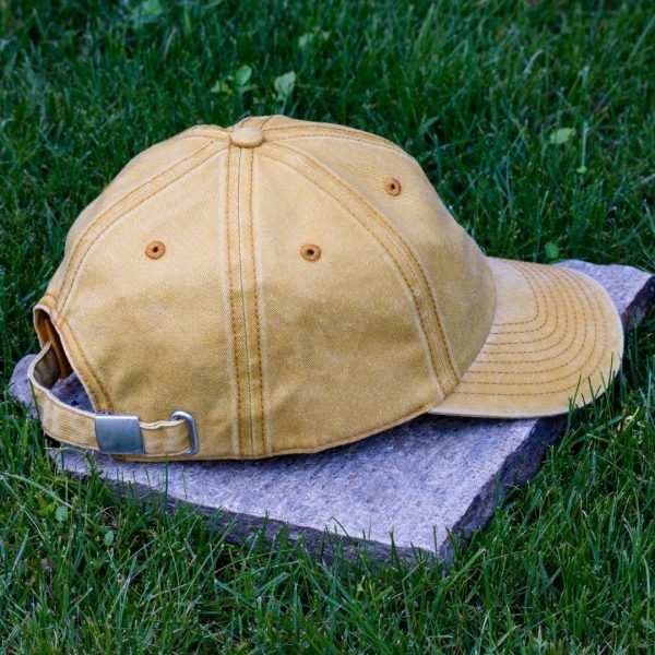 Back view of yellow vintage organic cotton baseball cap with adjustable metal buckle strap and washed finish