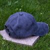 Back view of navy blue vintage cotton baseball cap with adjustable Velcro strap, washed finish and curved visor