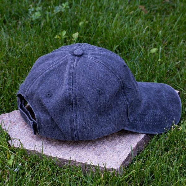 Back view of navy blue vintage cotton baseball cap with adjustable Velcro strap, washed finish and curved visor