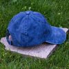 Back view of navy blue vintage cotton baseball cap with adjustable Velcro strap, washed finish and curved visor