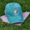 Green vintage cotton baseball cap with embroidered hiking bear design, washed finish and adjustable Velcro strap
