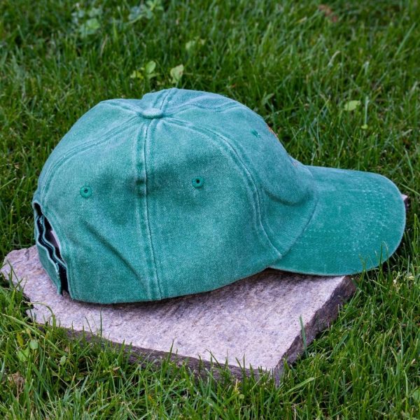 Back view of green vintage cotton baseball cap with adjustable Velcro strap, washed finish and curved visor