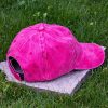 Back view of pink vintage cotton baseball cap with adjustable Velcro strap, washed finish and curved visor