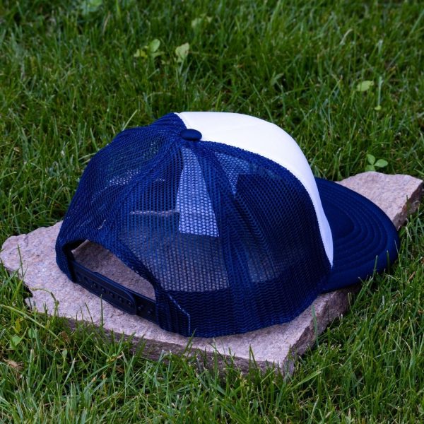 Rear view of white and navy blue kids mesh cap made from durable material with adjustable plastic closure and breathable navy mesh back.