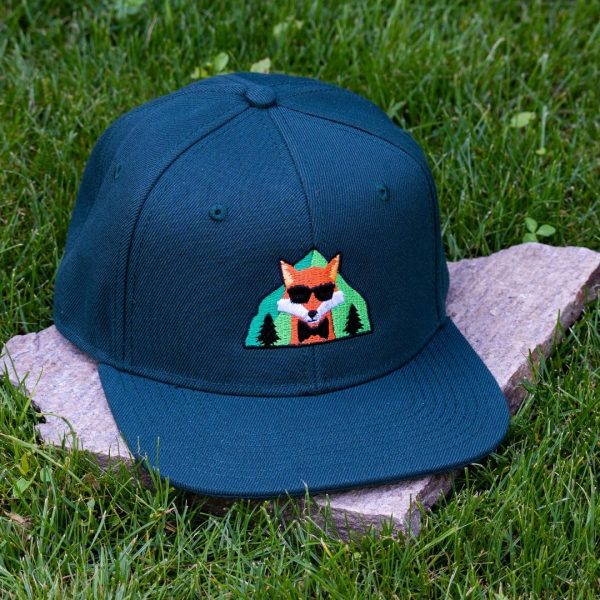 Front view of dark green flat brim cap made from 100% recycled micro twill with embroidered fox wearing sunglasses