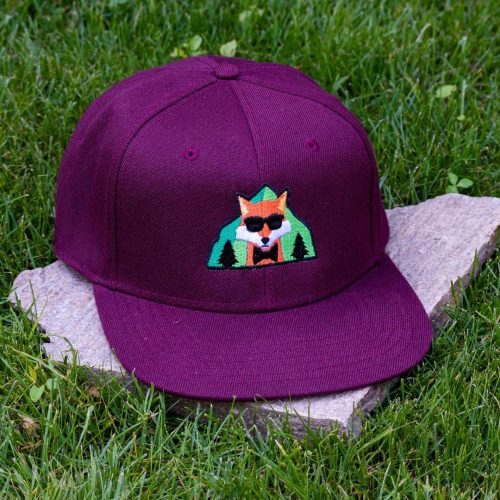 Front view of burgundy flat brim cap made from 100% recycled micro twill with embroidered fox wearing sunglasses
