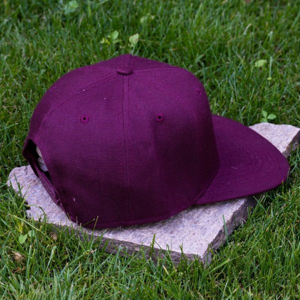 Back view of burgundy flat brim cap made from 100% recycled micro twill with adjustable snapback closure