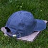 Back view of grey vintage organic cotton baseball cap with adjustable metal buckle, washed finish and curved visor