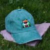 Green vintage cotton baseball cap with embroidered fox wearing sunglasses, washed finish and adjustable Velcro strap