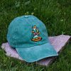 Green vintage cotton baseball cap with embroidered Meowtain Climber cat, washed finish and adjustable Velcro strap